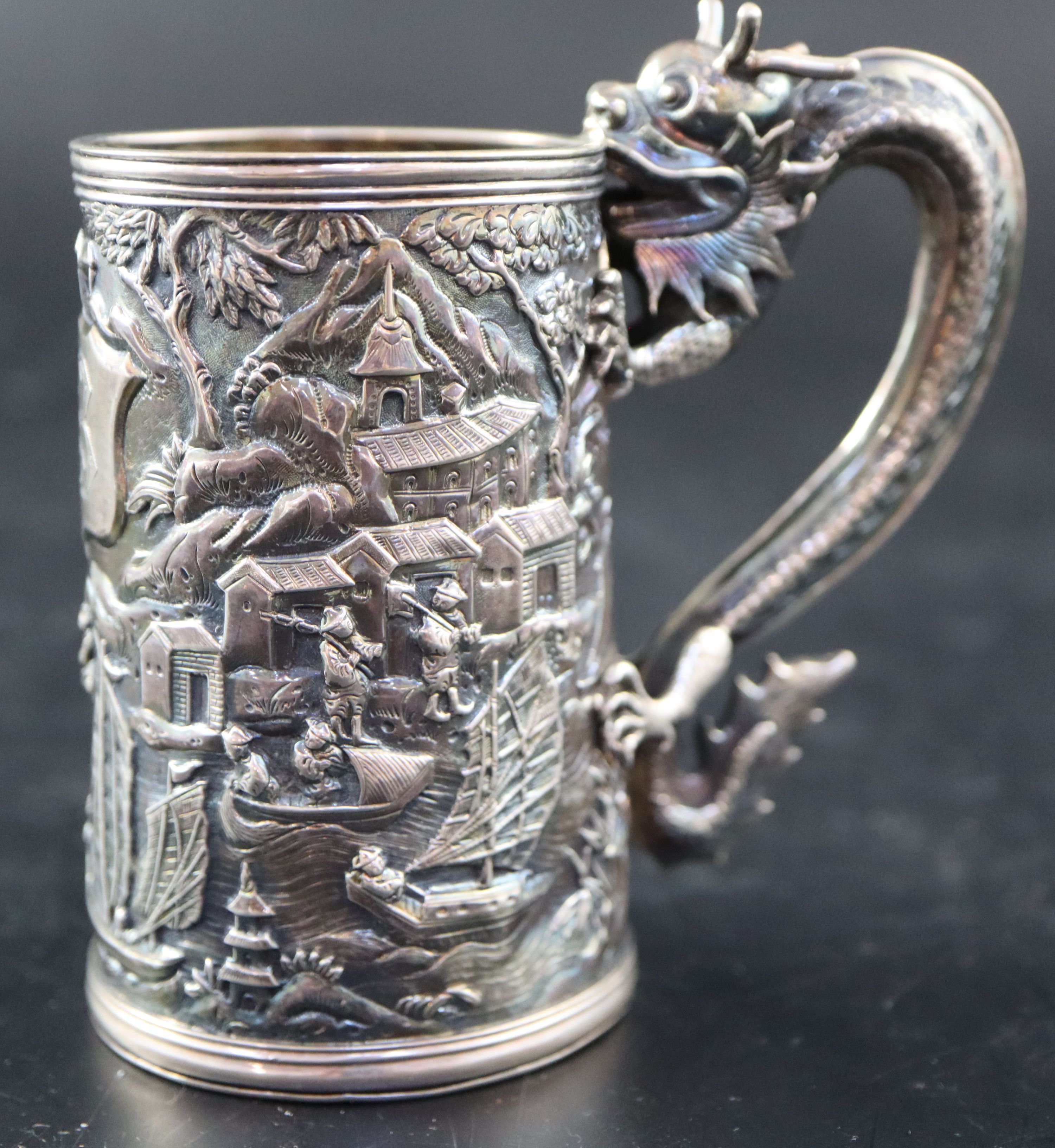 An early 20th century Chinese Export white metal christening mug by Wang Hing, with dragon handle